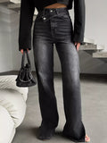 Black high-waisted jeans with a slit hem.