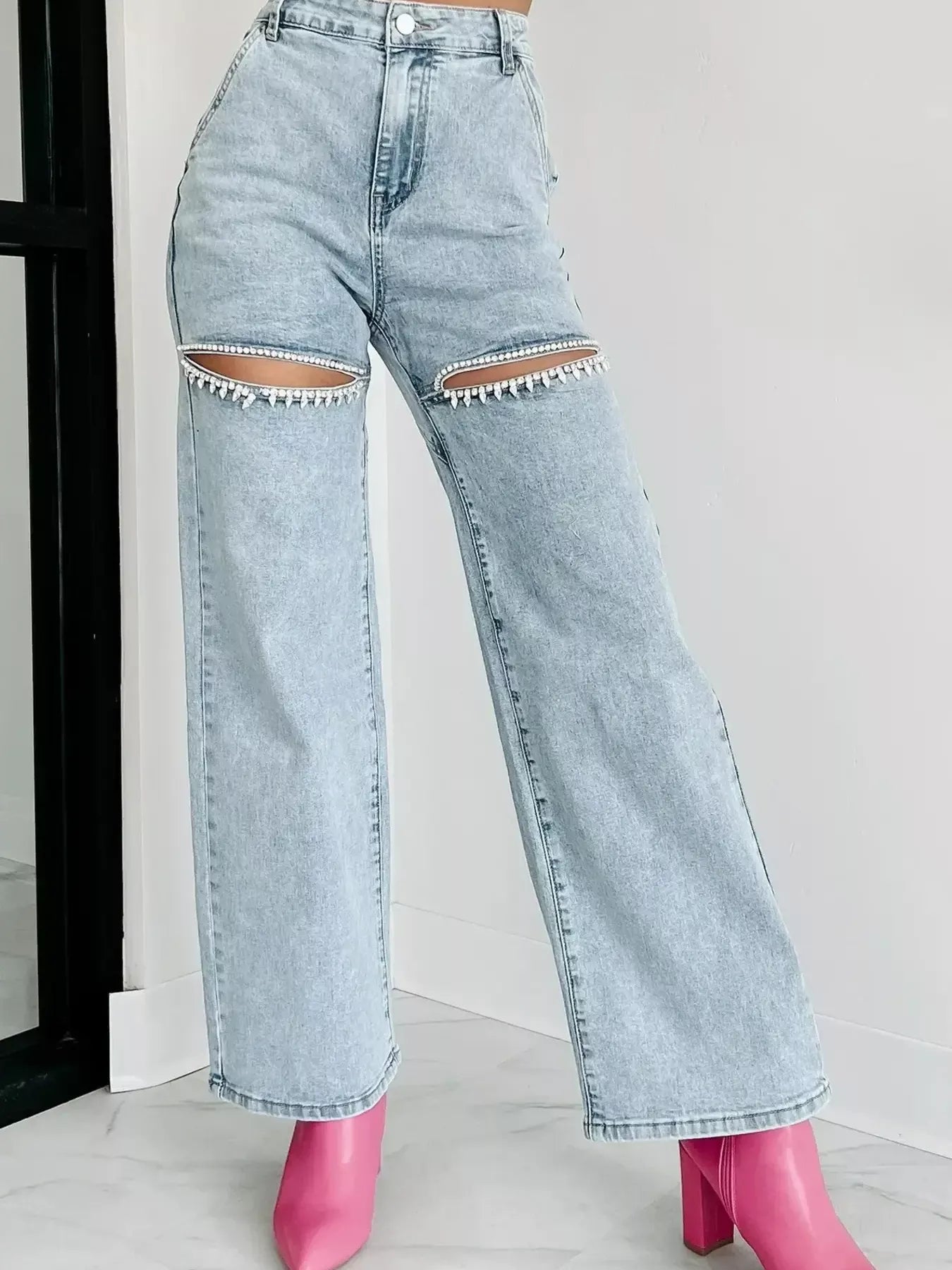Light blue high waist wide leg jeans with cut-out detailing.
