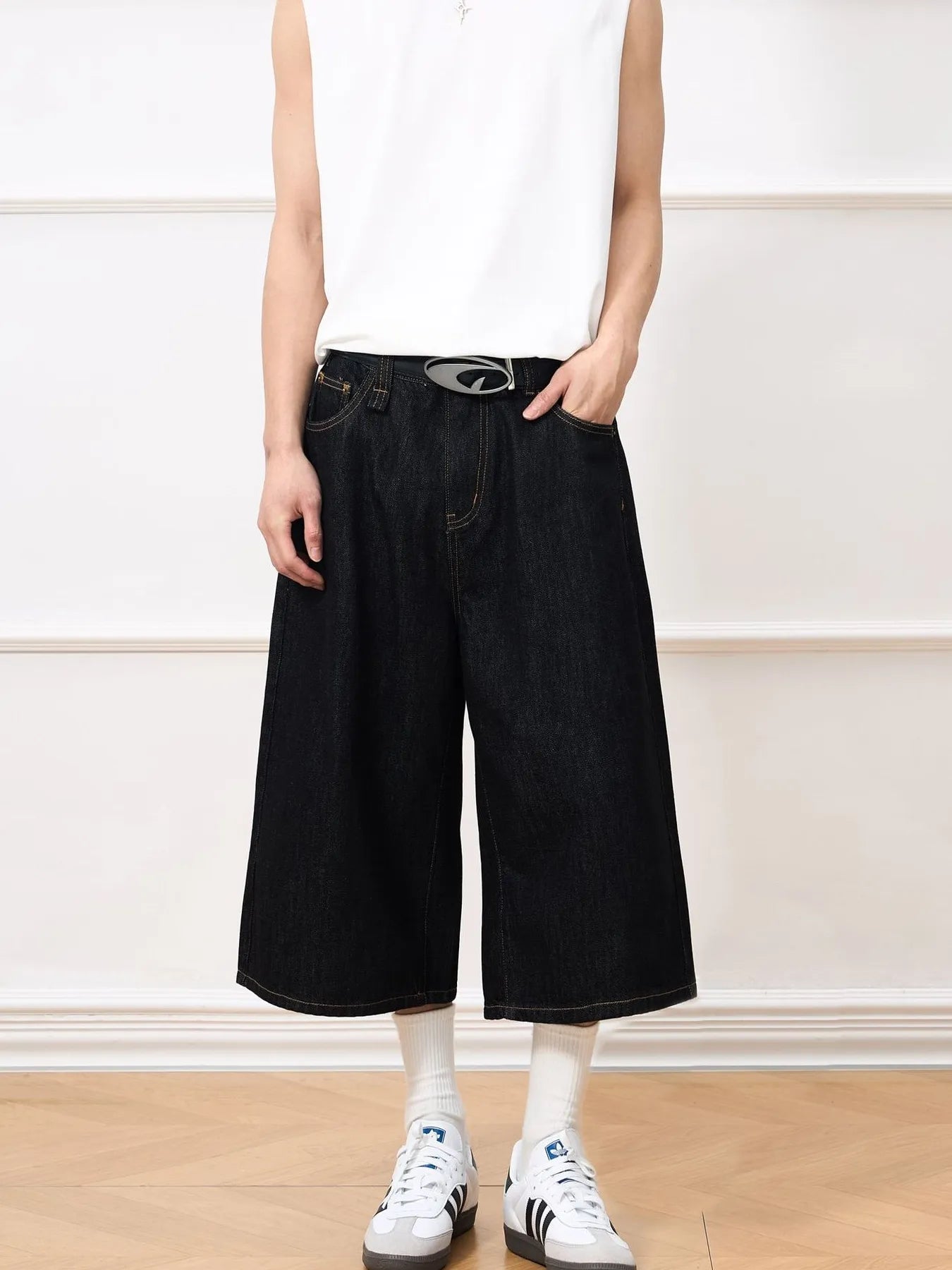 Men's black wide leg denim shorts.
